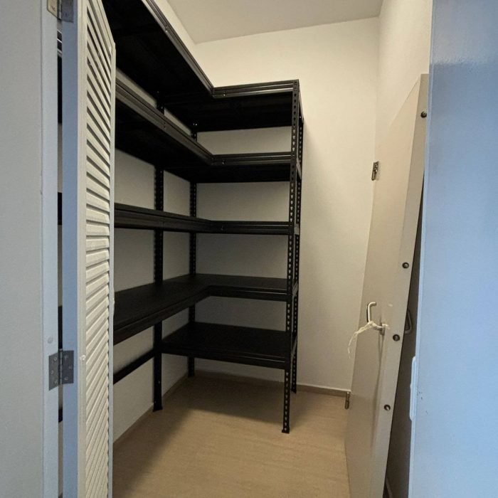 worker inspecting inventory on metal storage racks